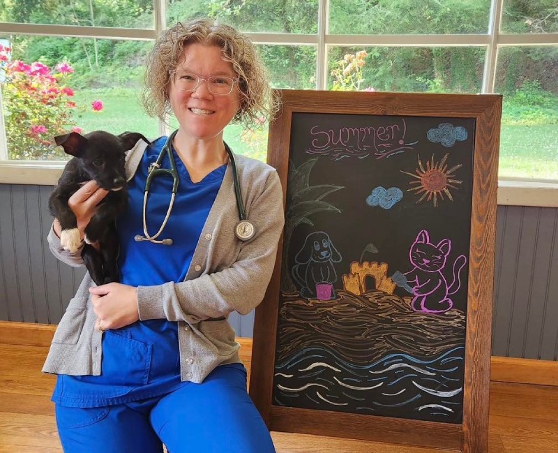 Dr. Melissa Hawkins holding a black dog